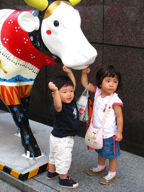 'Kids posing with the cows'